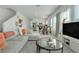 Bright, open-concept living room with neutral tones, plush seating, and large windows at 3270 Water Sprite St, Orlando, FL 32808