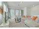 Bright living room with plush seating, large windows, and neutral tones at 3270 Water Sprite St, Orlando, FL 32808