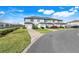 Street view showcasing townhouses with attached garages and manicured lawns at 3270 Water Sprite St, Orlando, FL 32808