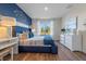 Beautiful bedroom with blue accents, a dresser and a bright window at 3747 Bluethread Way, Poinciana, FL 34759