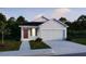 Charming single-story home with a two-car garage and well-maintained lawn at 3856 Bluethread Way, Poinciana, FL 34759