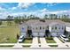 An aerial of townhomes with solar panels and lots of green space at 421 Sedgewick Dr, Davenport, FL 33837