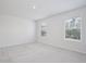 Spacious bedroom with plush carpeting and natural light from two large windows at 421 Sedgewick Dr, Davenport, FL 33837