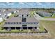 View of modern townhomes featuring solar panels, manicured landscaping, and covered patios in a vibrant community at 421 Sedgewick Dr, Davenport, FL 33837