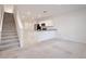 Open floor plan includes the kitchen, a staircase, and a carpeted living area at 421 Sedgewick Dr, Davenport, FL 33837