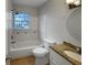 Bathroom with vanity, granite countertop, tiled shower and bathtub, and natural light at 4561 Evers Pl, Orlando, FL 32811