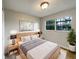 Cozy bedroom with a comfortable bed, side tables, and a window at 4561 Evers Pl, Orlando, FL 32811
