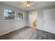 Bedroom with carpet, windows, ceiling fan, and bathroom access at 4561 Evers Pl, Orlando, FL 32811