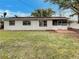 The home's exterior with a screened-in patio boasts a lawn and a classic facade at 4561 Evers Pl, Orlando, FL 32811