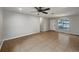 Open living area featuring tile floors, neutral paint, ceiling fan, and front door at 4561 Evers Pl, Orlando, FL 32811