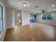 Open living area featuring tile floors, neutral paint, ceiling fan, and kitchen access at 4561 Evers Pl, Orlando, FL 32811