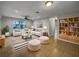 Bright living room featuring tile floors, white furniture with striped pillows, and a ceiling fan at 4561 Evers Pl, Orlando, FL 32811
