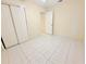 Bedroom featuring neutral walls and tile flooring with sliding door closet at 4882 S Semoran Blvd # 1408, Orlando, FL 32822