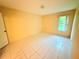 Simple bedroom with tile flooring and natural light at 4882 S Semoran Blvd # 1408, Orlando, FL 32822