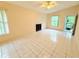 Spacious living room with tile floors, fireplace and access to private balcony at 4882 S Semoran Blvd # 1408, Orlando, FL 32822