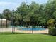 Community pool surrounded by mature landscaping and lounge chairs at 4882 S Semoran Blvd # 1408, Orlando, FL 32822