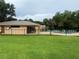 Community pool next to clubhouse surrounded by lush mature landscaping at 4882 S Semoran Blvd # 1408, Orlando, FL 32822
