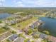 Aerial view of a lakeside home featuring a backyard with mature trees at 524 Quail View Ct, Debary, FL 32713