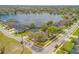 An aerial view of a lakeside residence showcasing a serene neighborhood and lush greenery at 524 Quail View Ct, Debary, FL 32713
