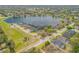 Aerial view of a lakeside community showcasing a beautiful lake and well-manicured lawns at 524 Quail View Ct, Debary, FL 32713
