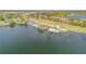 Aerial view of a lakeside community pool surrounded by lush trees and peaceful scenery at 524 Quail View Ct, Debary, FL 32713