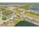 An aerial view of a lakeside home with mature trees and a beautiful backyard at 524 Quail View Ct, Debary, FL 32713