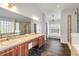 Bathroom with dual vanity, large mirror, walk-in shower, and soaking tub at 524 Quail View Ct, Debary, FL 32713