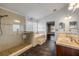 Elegant bathroom featuring a glass shower, soaking tub, and double vanity with modern fixtures at 524 Quail View Ct, Debary, FL 32713