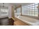 Bathroom featuring a soaking tub, glass block window and a walk-in shower at 524 Quail View Ct, Debary, FL 32713