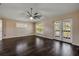 Cozy bedroom with dark wood floors, a ceiling fan, and a view to the back yard at 524 Quail View Ct, Debary, FL 32713