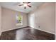 Bright bedroom with wood floors, ceiling fan, closet and a large window at 524 Quail View Ct, Debary, FL 32713