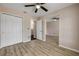 Comfortable bedroom with wood flooring, large closet, and views to the hallway at 524 Quail View Ct, Debary, FL 32713
