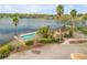 A community pool is situated by the lakeside, complete with palm trees and a charming pool house at 524 Quail View Ct, Debary, FL 32713