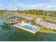 A community pool is situated by the lakeside, complete with lounge chairs and palm trees at 524 Quail View Ct, Debary, FL 32713