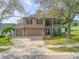Two-story home featuring a three-car garage and manicured front lawn at 524 Quail View Ct, Debary, FL 32713