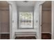 Hallway view with walk-in closet featuring built-in shelving for optimal storage solutions at 524 Quail View Ct, Debary, FL 32713