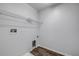 Bright laundry room with hardwood floors, utility connections, and wire rack at 524 Quail View Ct, Debary, FL 32713