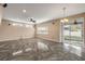 Spacious living area featuring a ceiling fan, sliding glass doors, and plenty of natural light at 524 Quail View Ct, Debary, FL 32713