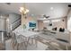 Open-concept living area with dining space, a modern ceiling fan, and a large TV at 524 Quail View Ct, Debary, FL 32713