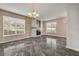 Bright living room with a modern fireplace, elegant chandelier, and abundant natural light at 524 Quail View Ct, Debary, FL 32713