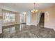 Inviting living area with ample natural light, a staircase, and a decorative chandelier at 524 Quail View Ct, Debary, FL 32713