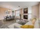 Stylishly decorated living room with a cozy fireplace, dining area, and comfortable seating at 524 Quail View Ct, Debary, FL 32713