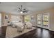 Well-lit bedroom featuring elegant furnishings, dark wood floors and access to exterior at 524 Quail View Ct, Debary, FL 32713