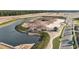 Aerial view of a community under construction showing lake, roads, and the early phases of development at 5350 Spoonflower Ct, St Cloud, FL 34771