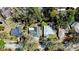 An aerial view of a neighborhood showcasing the rooftops of several single Gathering homes and mature trees at 5443 Aeolus Way, Orlando, FL 32808