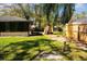 Fenced in backyard with green grass and mature landscaping at 5443 Aeolus Way, Orlando, FL 32808