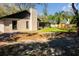 Back view of home featuring siding, chimney, sunroom and grassy lawn at 5443 Aeolus Way, Orlando, FL 32808