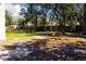 Backyard featuring partial shade, green grass, privacy fence, and mature landscaping at 5443 Aeolus Way, Orlando, FL 32808