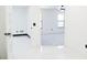 Bright bedroom with white walls, baseboards, light gray carpet, and black trim at 5443 Aeolus Way, Orlando, FL 32808
