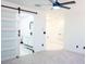Bedroom featuring modern ceiling fan and ensuite bathroom with sliding door at 5443 Aeolus Way, Orlando, FL 32808